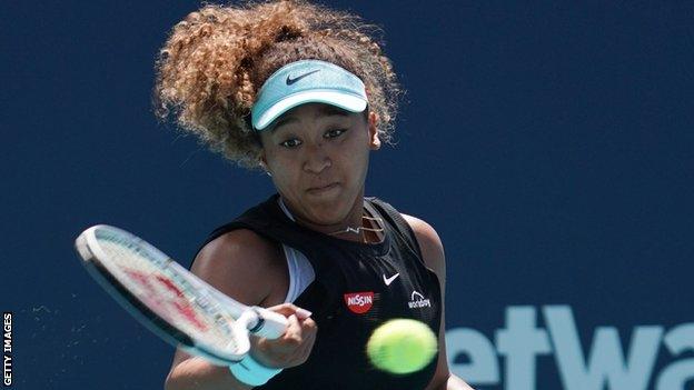 Naomi Osaka returns against Elise Mertens at the Miami Open