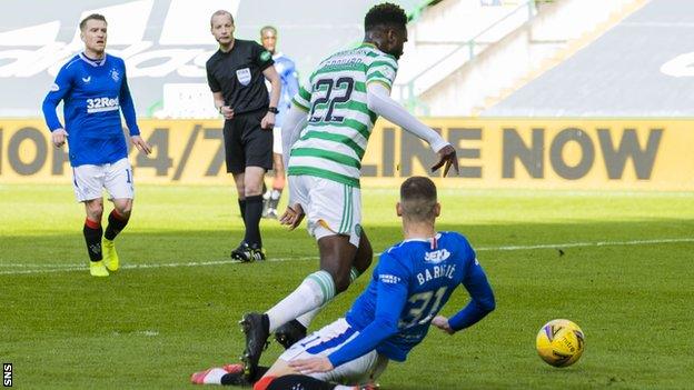 Celtic striker Odsonne Edouard goes down after a challenge from Rangers' Borna Barisic