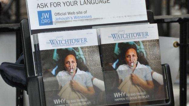 A leaflet stand showing copies of the Watchtower