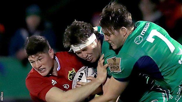 Munster's Jack O'Donoghue is tackled by Connacht's Jake Heenan and James Cannon