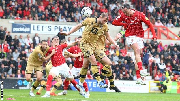 Harry McKirdy scores for Swindon against Port Vale.