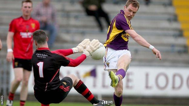 Down keeper Stephen Kane keeps out Kevin O'Grady's shot