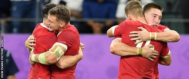 Wales players hug each other at the final whistle of their win against France in the quarter final of the 2019 Rugby World Cup