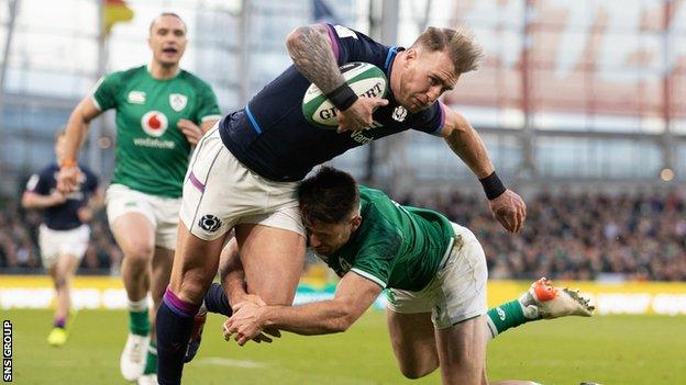 Scotland captain Stuart Hogg is knocked into touch by Hugo Keenan