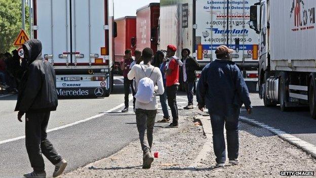 Migrants near trucks heading to the UK