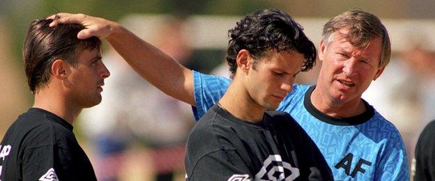 Ryan Giggs (C) looks unhappy as Sir Alex Ferguson puts a hand on Clayton Blackmore's head in South Africa in 1993