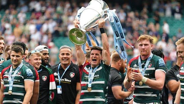 Freddie Burns holds the Premiership trophy aloft