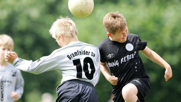 Kids heading footballs