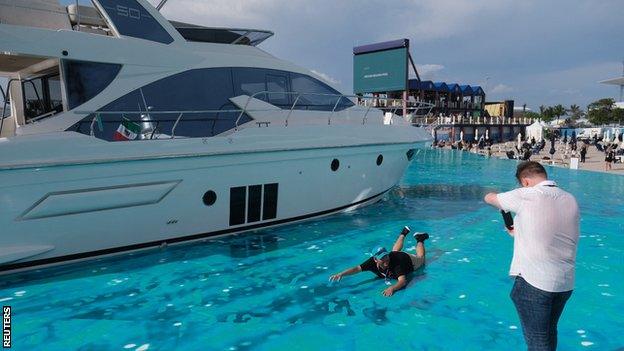 Fans take pictures in the fake marina at the Miami Grand Prix