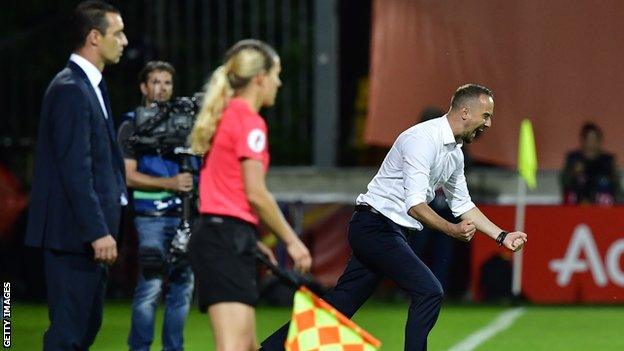 Mark Sampson celebrates