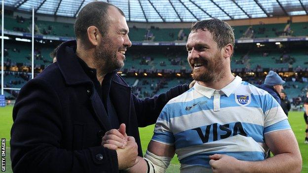 Argentina head coach Michael Cheika shakes hands with Julian Montoya after the final whistle