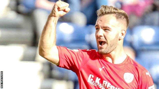 Adam Armstrong celebrates his goal for Barnsley