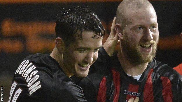 Joshua Robinson congratulates Crusaders scorer Stephen O'Flynn