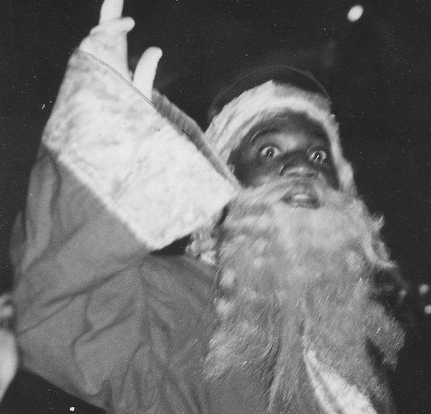 The entertainer Bojangles in a Santa Claus costume waving to a crowd, 1937. (Photo by Afro American Newspapers/Gado/Getty Images)