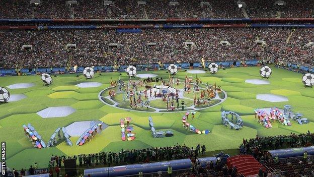 Performers spell out the world welcome during the opening ceremony