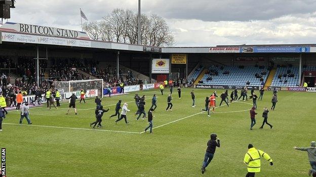 Scunthorpe fans invade the pitch