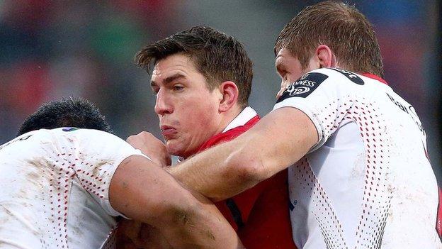 Man of the match Ian Keatley is tackled by Ulster forwards Nick Williams and Chris Henry