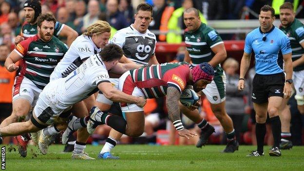 Leicester's Nemani Nadolo is tackled by Sale Sharks' Tom Curry and Tommy Taylor