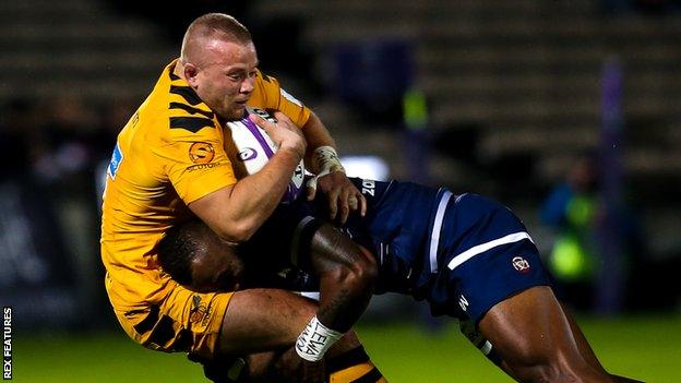 Tom Cruse of Wasps is tackled in his side's defeat against Bordeaux