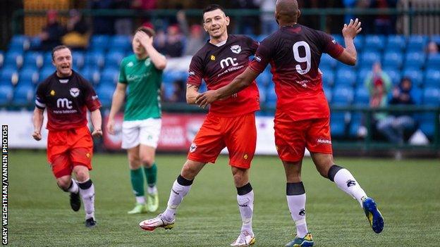 Players celebrate after goal