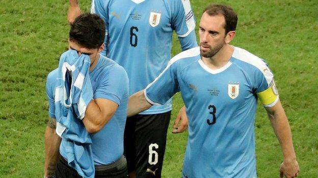 Diego Godin consoles Luis Suarez after Uruguay are knocked out of the Copa America