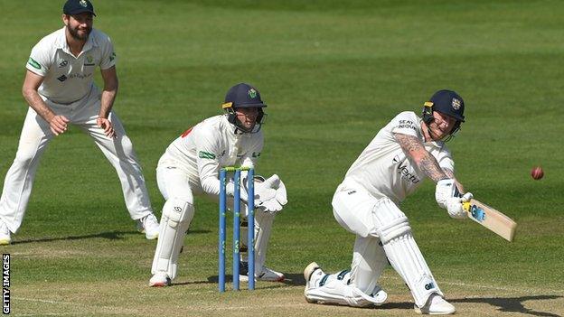 Ben Stokes sweeps as Chris Cooke looks on