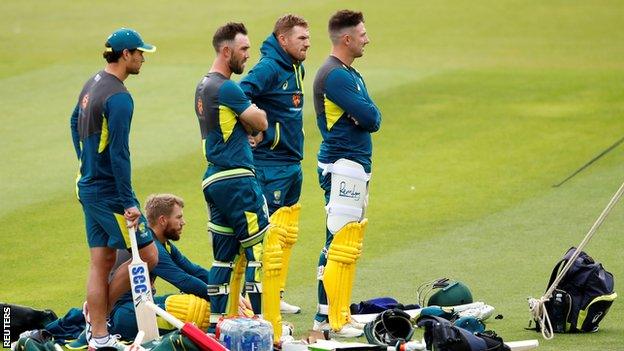 Australia players look on as net bowler Jaykishan Plaha is treated at the Oval