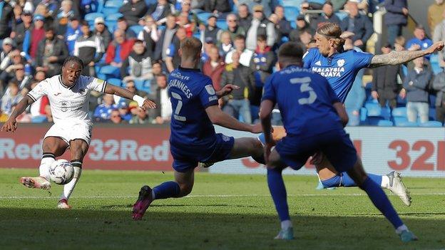 Michael Obafemi of Swansea City scores against Cardiff City