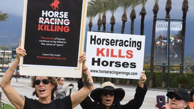 Protestors gather outside the Santa Anita race track