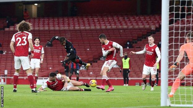 Wilfried Zaha is denied by a block from Granit Xhaka