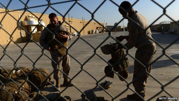 US Marines arrange their equipment as British and US troops withdraw from the Camp Bastion-Leatherneck complex in Helmand in 2014