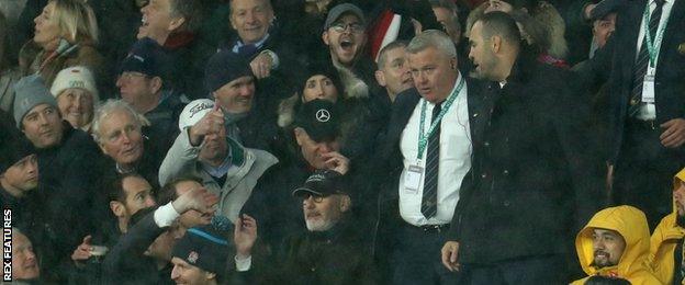 Michael Cheika exchanges words with home supporters as he leaves the coaches' box during the second half