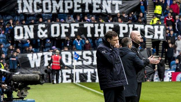 Rangers manager Graeme Murty in front of fan protest banners at Ibrox