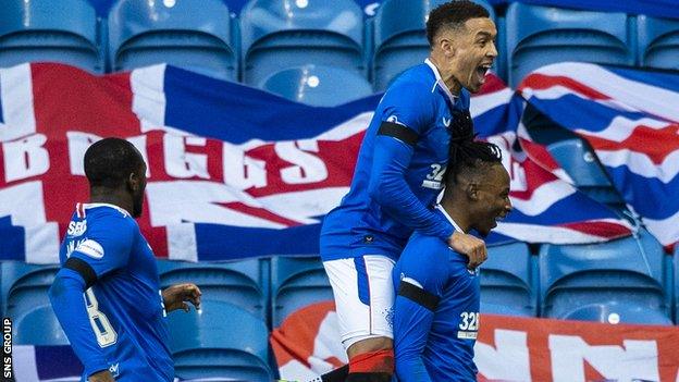 Joe Aribo, Glen Kamara, and James Tavernier celebrate Rangers' goal against Celtic