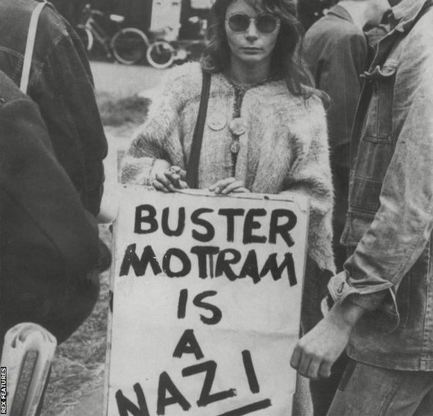 A woman holding 'Buster Mottram is a Nazi' banner during Britain's Davis Cup tie against Austria in Bristol in June 1978