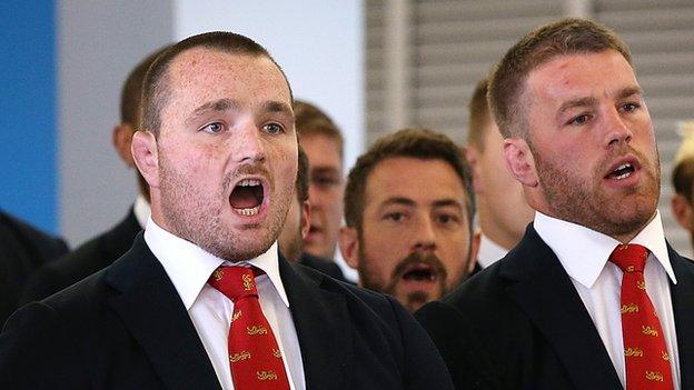 Ken Owens (L) sings on arrival in New Zealand