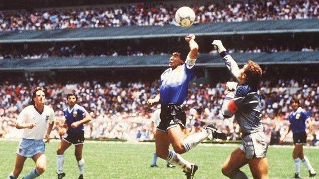 Argentina's Maradona uses his hand to beat England's Peter Shilton to the ball