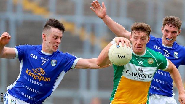 Cavan defender Dara McVeety challenges Offaly's Michael Brazil at O'Connor Park