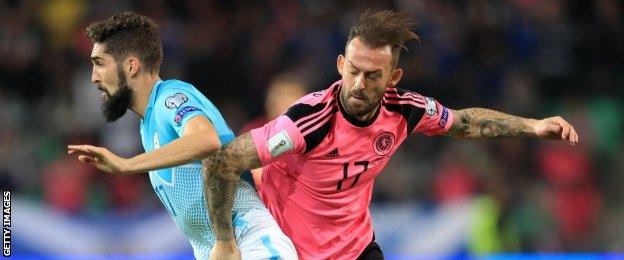 Steven Fletcher contests the ball against Slovenia