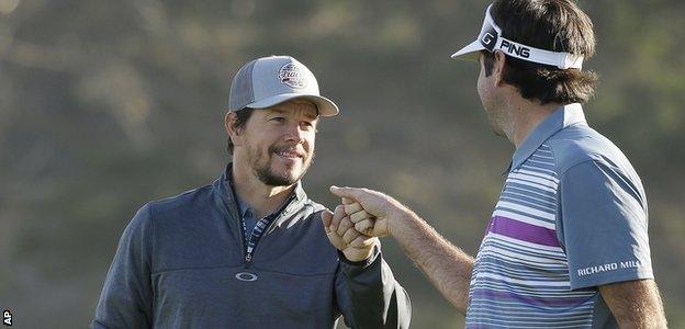 Actor Mark Wahlberg fist pumps with world number six golfer Bubba Watson