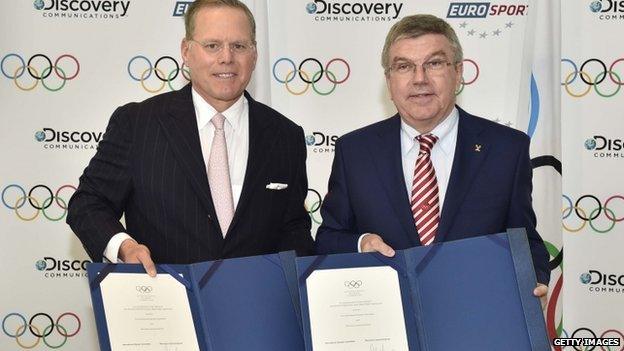 President and CEO of Discovery Communications David Zaslav (L) and IOC President Thomas Bach posing after a signing ceremony at the IOC headquarters in Lausanne