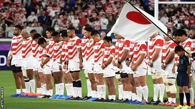 Japan players sing the national anthem