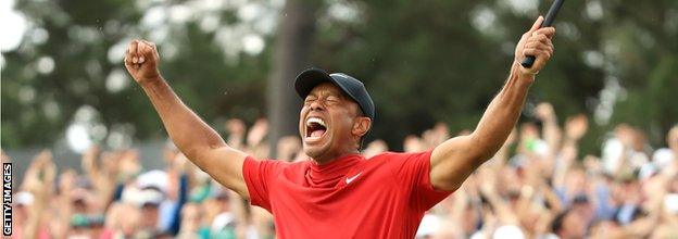 Tiger Woods of the United States celebrates on the 18th green after winning the Masters at Augusta National Golf Club on April 14, 2019 in Augusta, Georgia