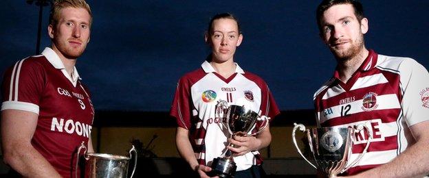 Paudie McGuigan, Louise Dougan and Gerald Bradley holding Slaughtneil's Derry football, camogie and hurling trophies won in 2015