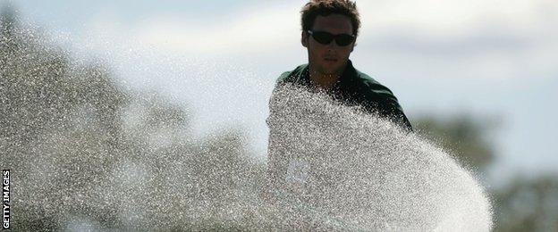 A course worker waters the seventh green during the final round of the 104th U.S. Open at Shinnecock Hills Golf Club on June 20, 2004 in Southampton, New York. (Photo by Jonathan Ferrey/Getty Images)