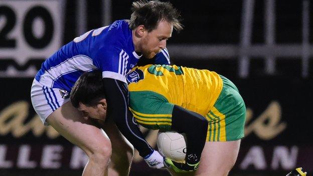 Cavan forward Seanie Johnston gets to grips with Donegal opponent Paddy McGrath at Breffni Park