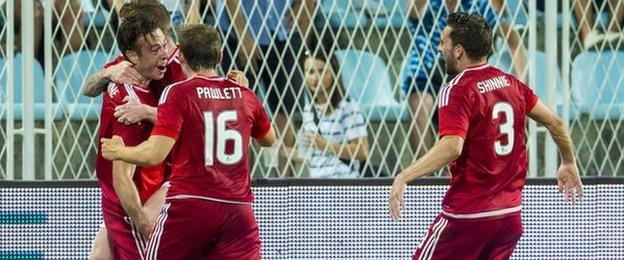 Andrew Considine (left) celebrates opening the scoring for Aberdeen against Rijeka