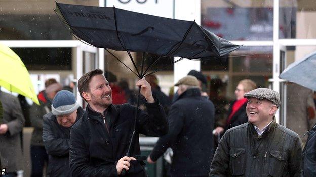 Man loses his umbrella in the wind