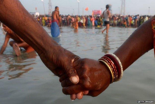 A couple hold hands