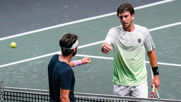 Cameron Norrie taps fists with Nikoloz Basilashvili after their match in Rotterdam